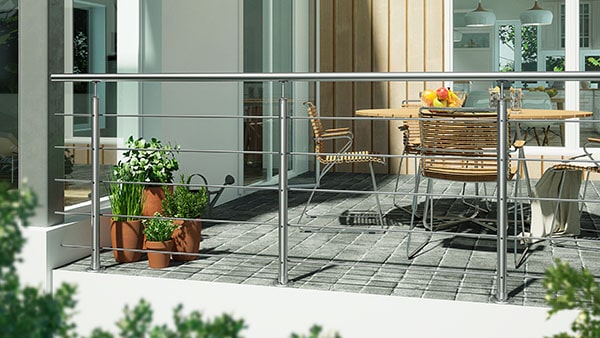 Harmony banister in stainless steel on balcony with patio furniture and plants